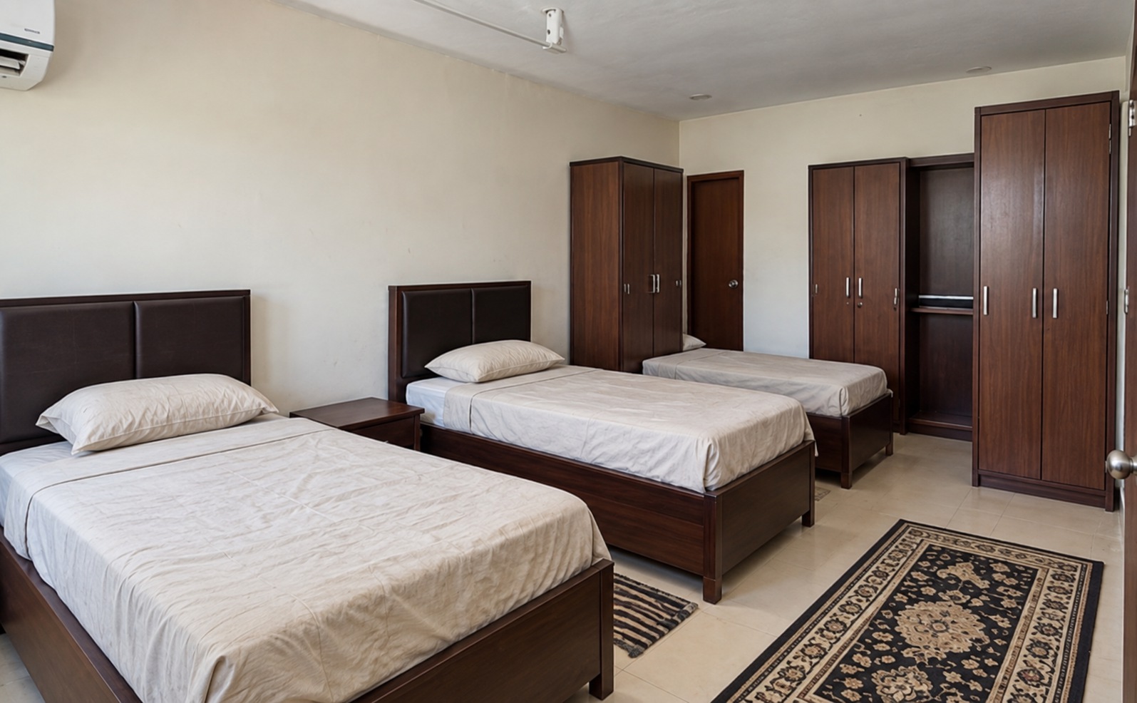 Illustrative shared room with beds and wardrobes